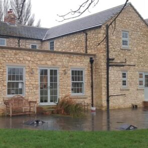 Grey uPVC sliding sash window installation